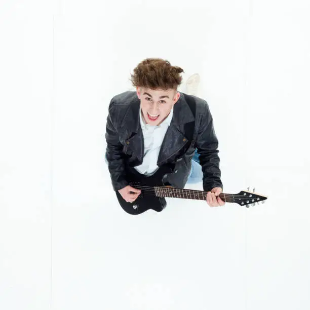 Photo of Directly above view of young man playing an electric guitar