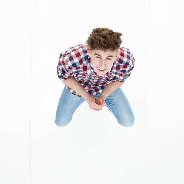 istock Top down view of young man sitting and looking up 949737210