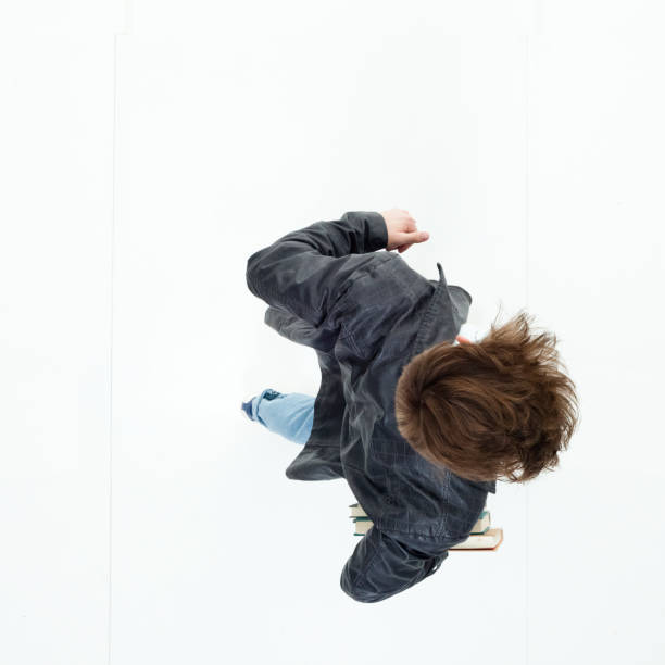 istock Directly above view of young man holding books 949739896
