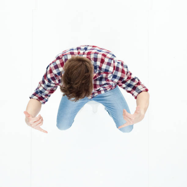 istock Top down view of young man sitting and cheering 949739978