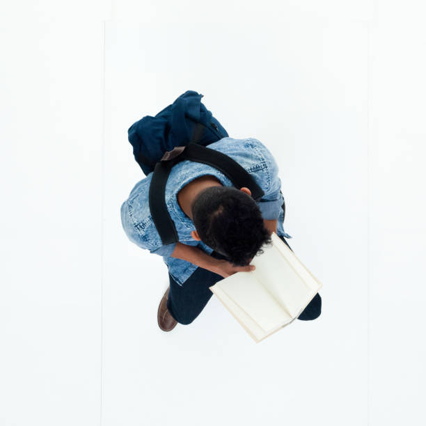istock Top view of African American man holding a book 949740230