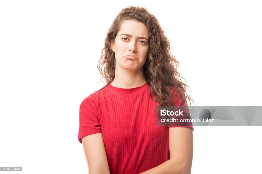 Cute woman looking sad Portrait of young caucasian woman looking sad on white background 20-29 Years Stock Photo