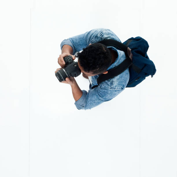 istock Top view of African American man using a camera 949745550