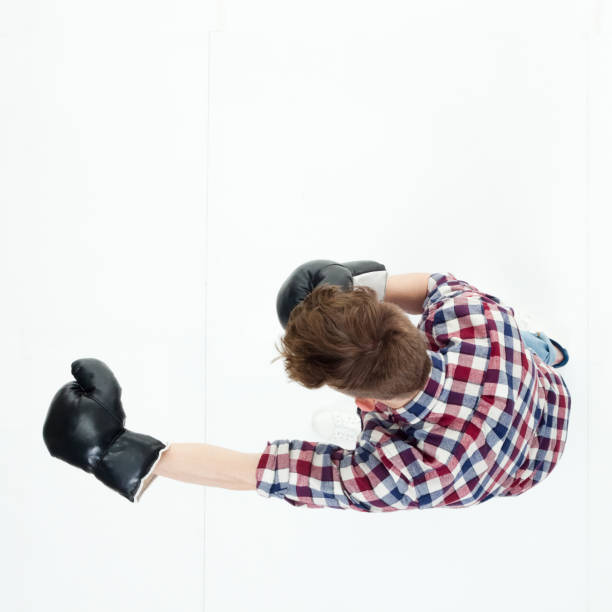 istock Top down view of young man punching with boxing gloves 949745600