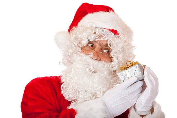istock Santa Claus holds a Christmas gift box beside his head 94974785