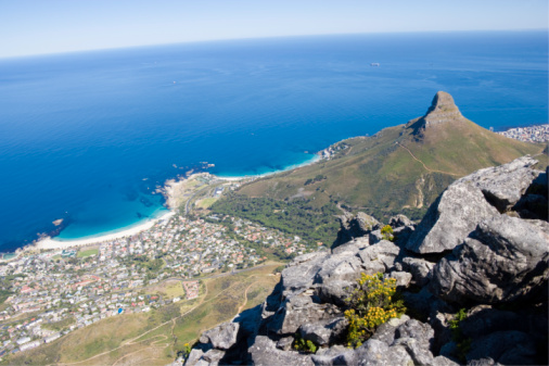 The view of Lions Head Rock from the top of Table Mountain with famed cable car on it's way down.