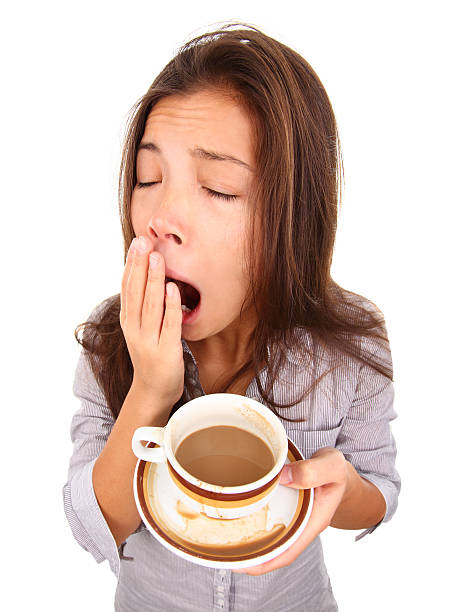 stanco di donna sbadigliare - yawning women drink coffee cup foto e immagini stock