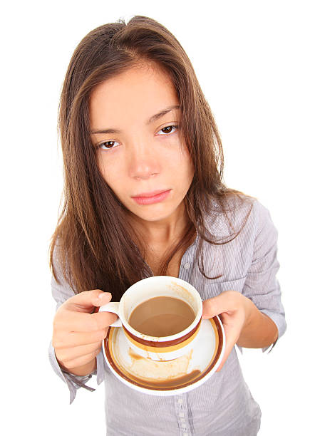 25 years old businesswoman after work in restaurant. She is having a headache, and she need to relax with coffee and some sweets