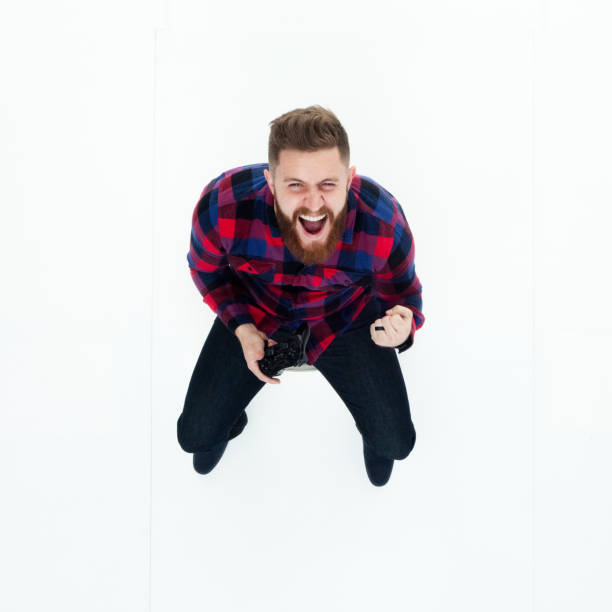 istock Directly above view of man holding a game controller 949774610