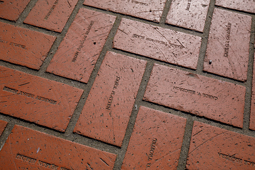 Portland, Oregon, USA - April 20, 2018 : Floor red bricks with engraving names at Pioneer Courthouse Square in Portland
