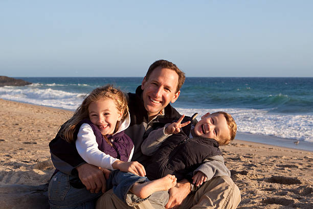 istock Young Family Laughing on the Beach 94978098