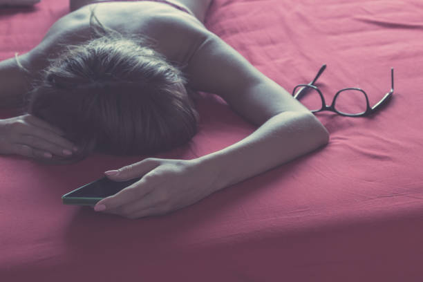 istock Woman with cellphone in bed - texting addiction. 949787052