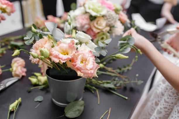istock Master class on making bouquets for kids. Spring bouquet in metal ornamental flowerpot. Learning flower arranging, making beautiful bouquets with your own hands 949790446