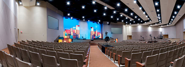 Panorama of Church Interior Panorama of Church Interior with Lit Stage. auditorium photos stock pictures, royalty-free photos & images