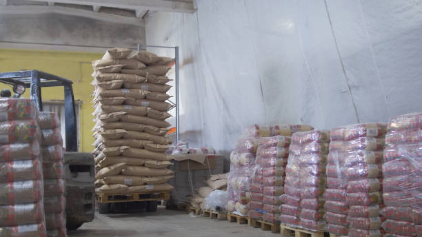 istock Loaders transport pallet with boxes on industrial warehouse 949808894