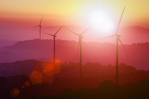 istock Wind turbines silhouette on mountains at sunset. 949811690