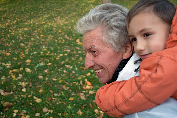 istock grandfather with grandson in the park 94981340