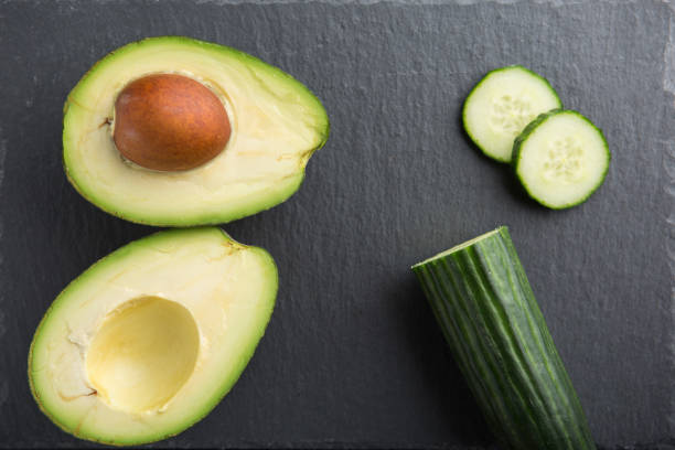 istock Green smoothie ingredients - avocado, cucumber on a dark background 949826962