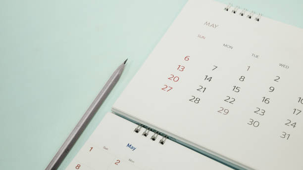 istock blurred calendar close up on May planning concept. 949827566
