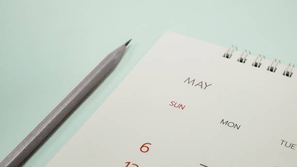 istock blurred calendar close up on May planning concept. 949827604