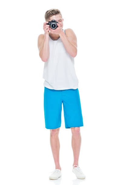 istock Young man wearing tank top holding camera 949834378
