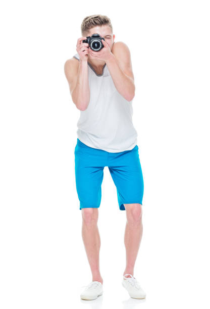 istock Young man wearing tank top holding camera 949834384