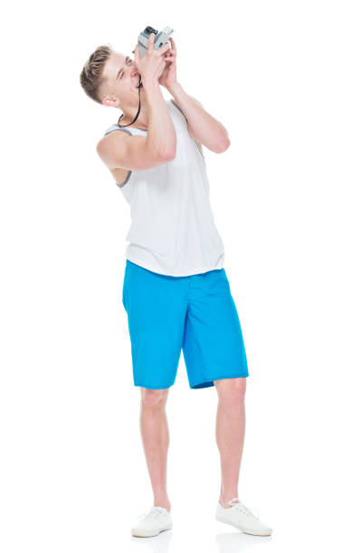 istock Young man wearing tank top holding camera 949834386