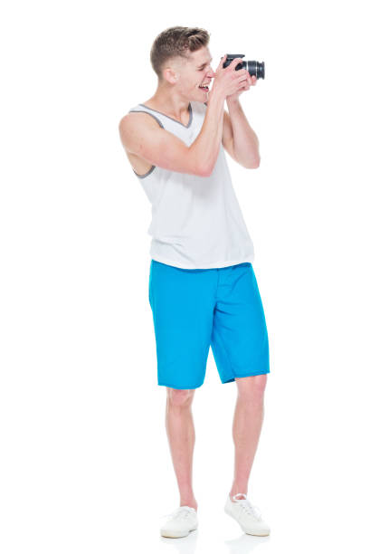 istock Young man wearing tank top holding camera 949834852