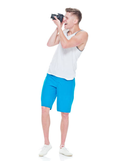 istock Young man wearing tank top holding camera 949834872
