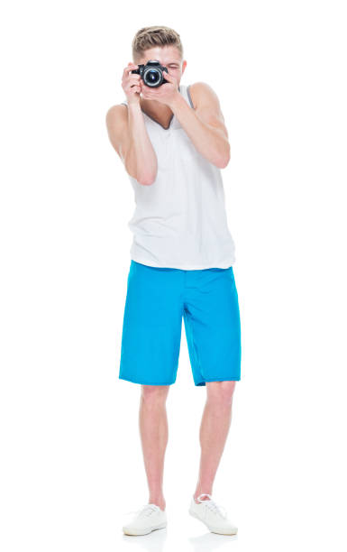 istock Young man wearing tank top holding camera 949835122