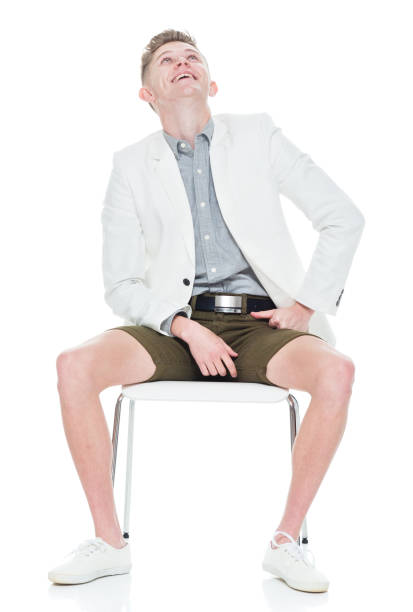 istock Attractive young man sitting on chair 949842436