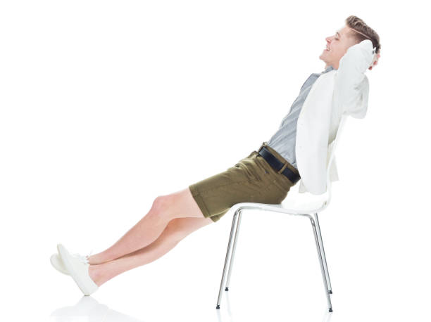 istock Attractive young man sitting on chair and relaxing 949842730