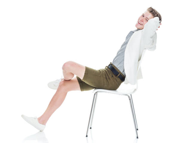 istock Attractive young man sitting on chair and relaxing 949842822