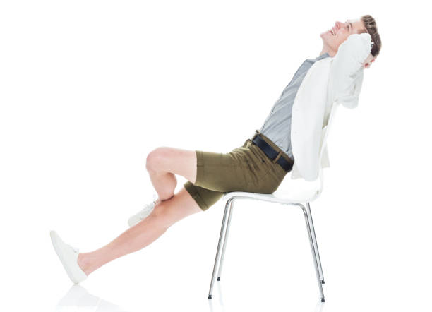 istock Attractive young man sitting on chair and relaxing 949842916
