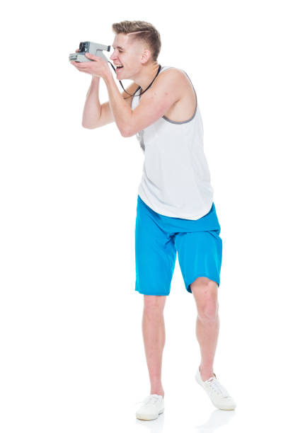 istock Young casually dressed man taking photos with a polaroid camera 949845466