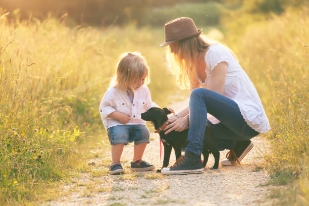 istock Little boy with his mother and puppy 949845718