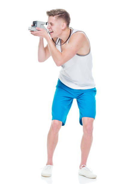 istock Young casually dressed man taking photos with a polaroid camera 949845760