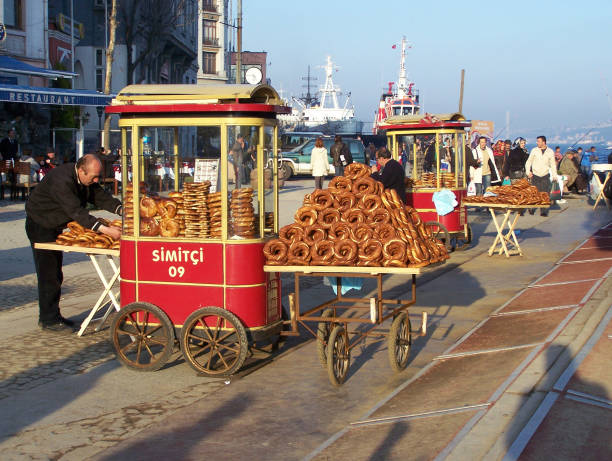 Simit (Turkish Bagel) Cart in Istanbul Istanbul,Turkey - March 01,2008 Simit seller cart at Karaköy district in Istanbul.Simit is a circular bread with covered sesame. turkish bagel simit stock pictures, royalty-free photos & images