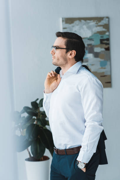 istock Handsome businessman wearing glasses looking in window 949851246