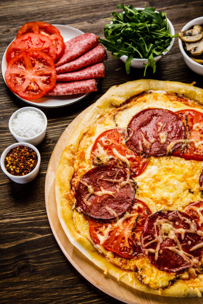 istock Pizza margherita on wooden background 949853866