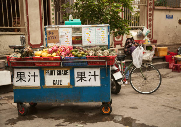 istock Street vendor cart selling tropical fruit and making drinks 949857312