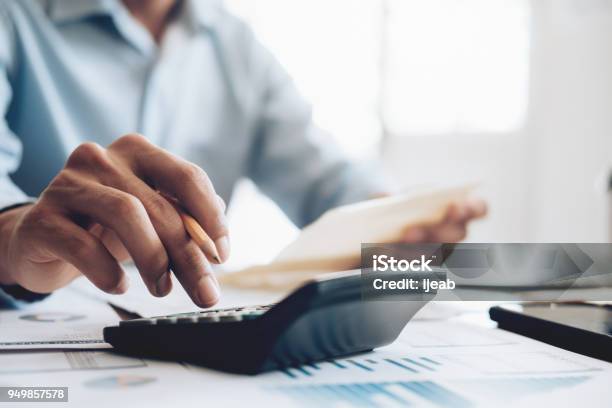 Male Accountant Or Banker Use Calculator Stock Photo - Download Image Now - Calculator, Tax, Mathematics