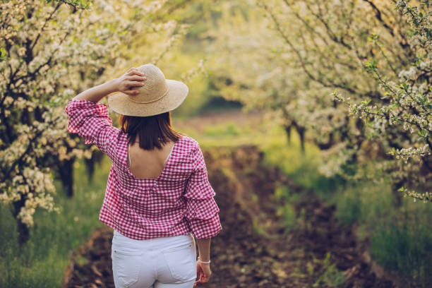 istock Woman standing in the orchard 949860278