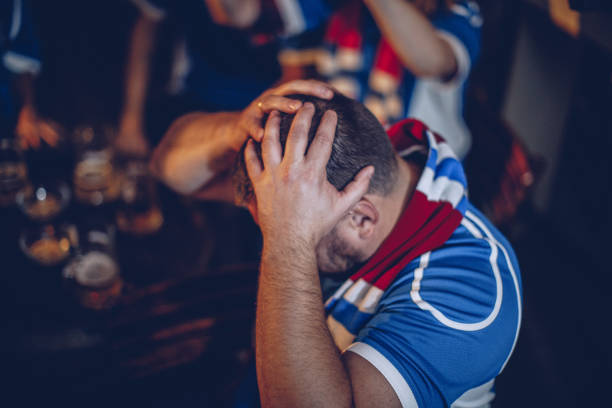 istock Watching football game in pub 949861290