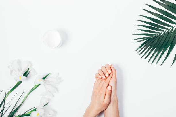 Flat lay woman applying cream on her hands