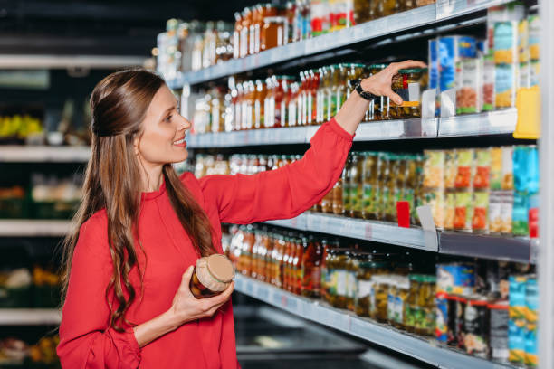 istock smiling woman choosing products in hypermarket 949865988