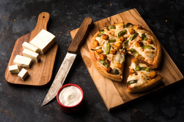 istock Indian Paneer Pizza with fresh cottage Cheese cubes and white sauce 949869174