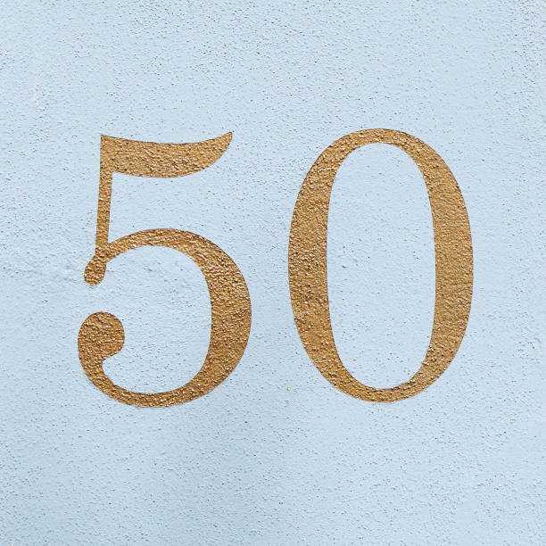 istock number 50 fifty in gold paint on blue wall 949870444