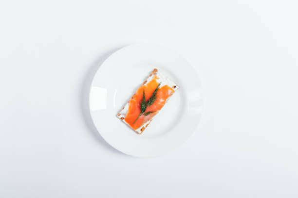 istock Top view plate with salmon sandwich 949870738
