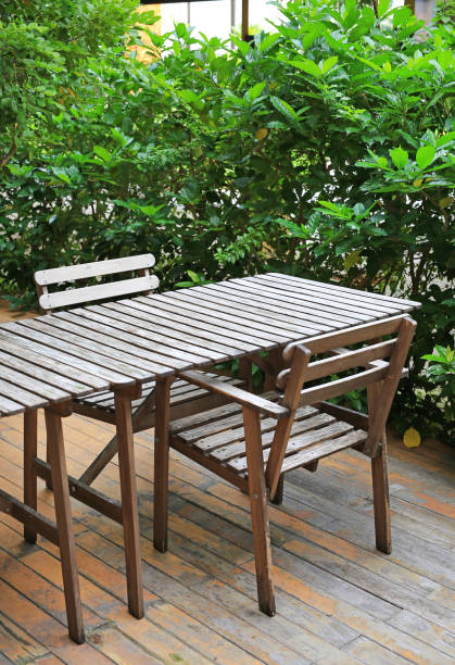 istock Empty wooden table and chair in the garden. 949874050